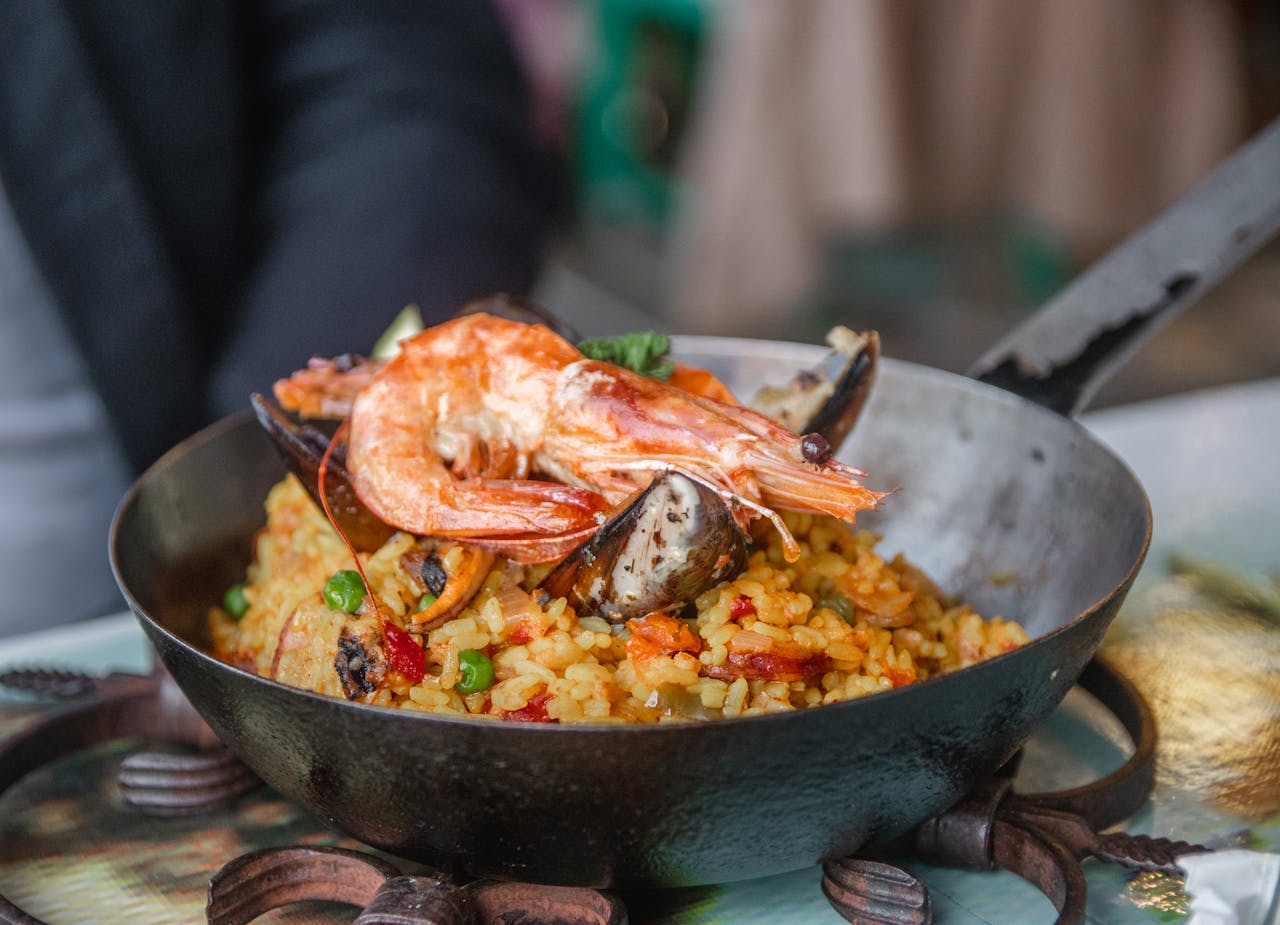 Savory seafood paella with shrimp and mussels, perfectly cooked in a rustic pan.